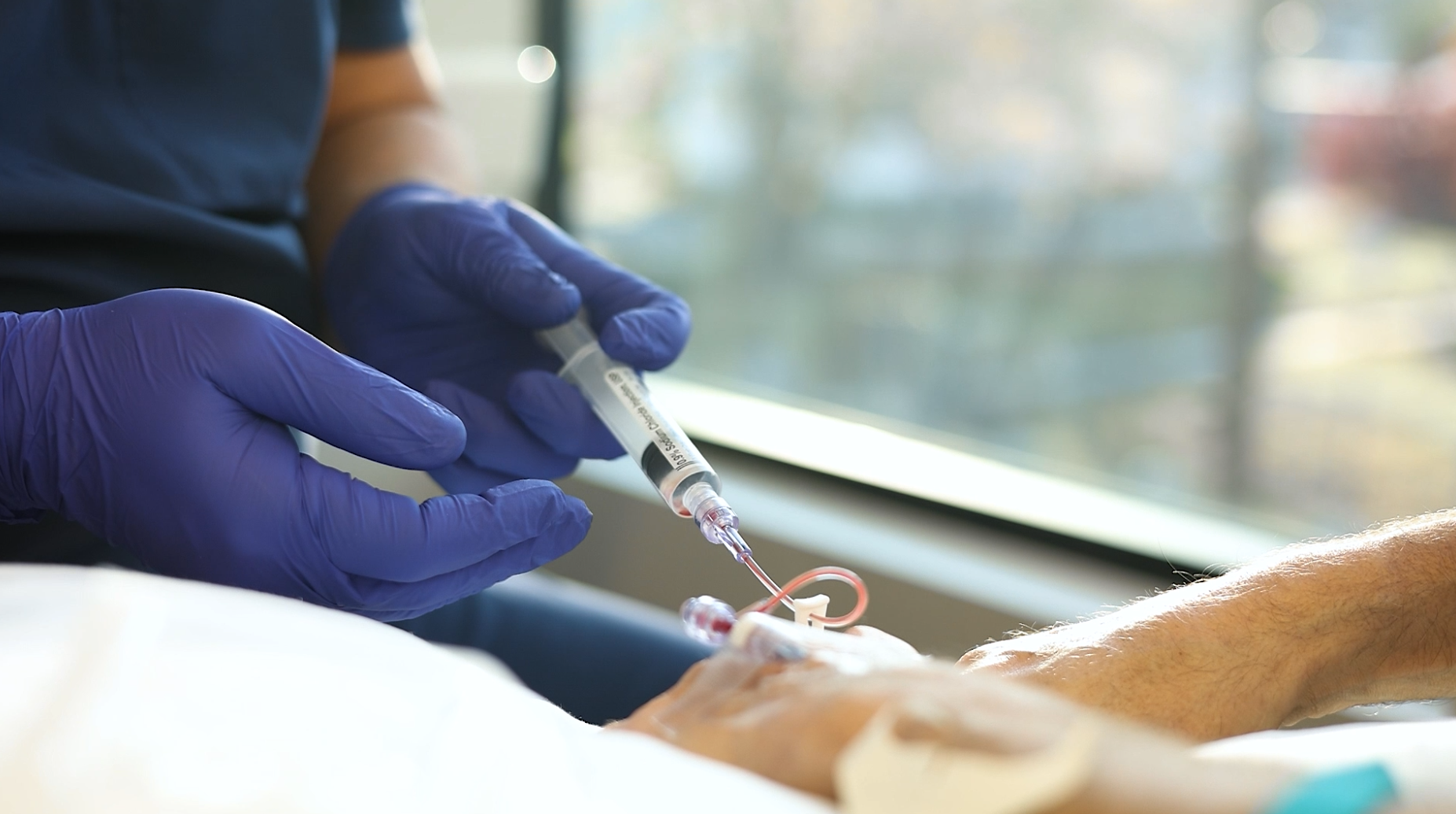 RN providing venipuncture alternative to patient 